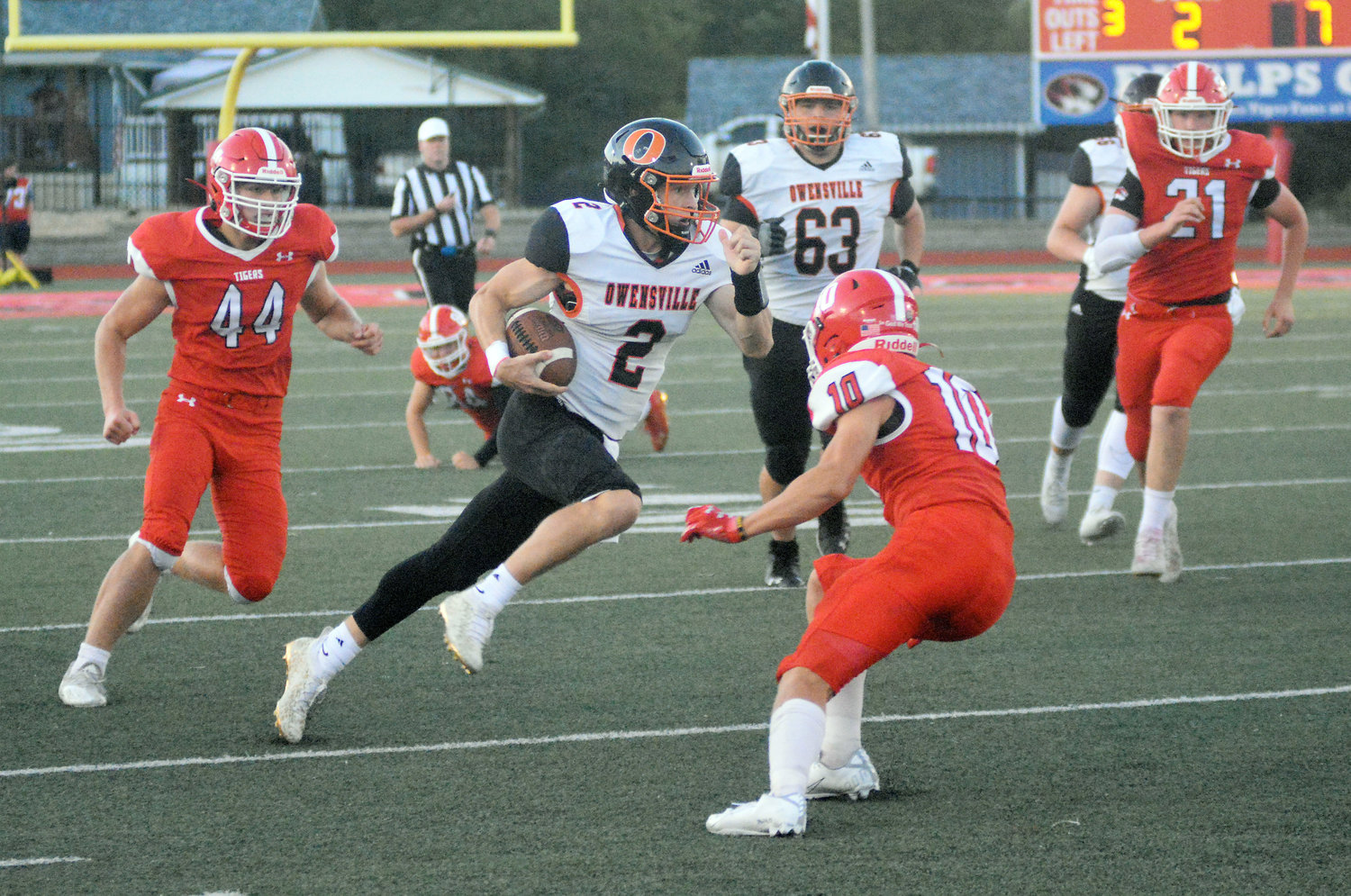 Brendan Decker (above, center) looks for open field to run in Friday night for Owensville’s Dutchmen during their 60-11 victory Friday night in Phelps County over St. James’ Tigers. Hayden Shoemaker (63) runs down the field hoping Decker finds the end zone.